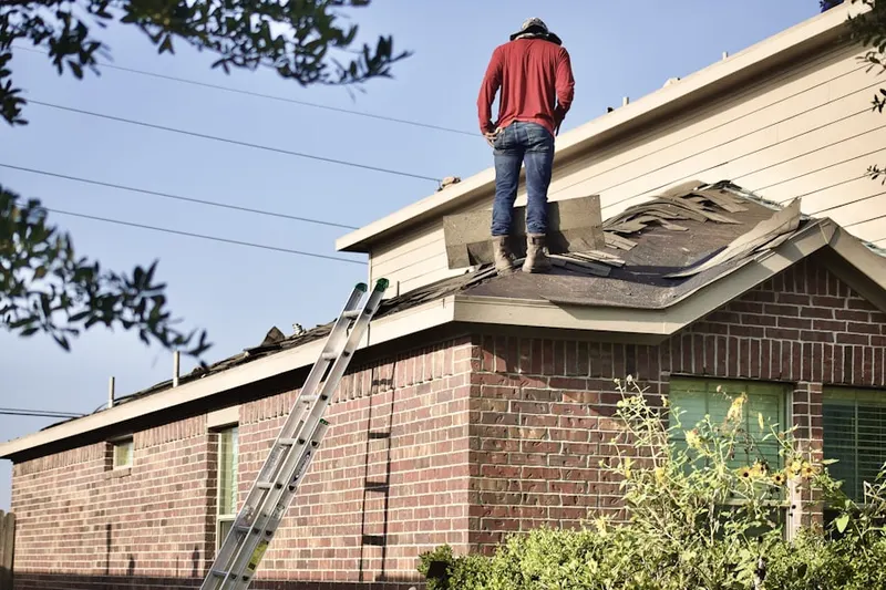 Professional roofer working on a residential roof in Belfair Crossroads